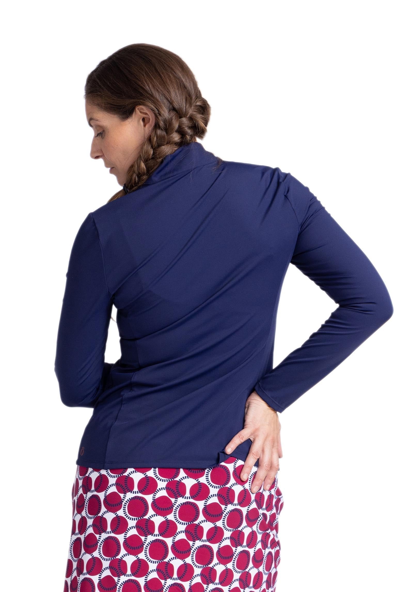 Back view of a woman wearing a long sleeve navy blue top.